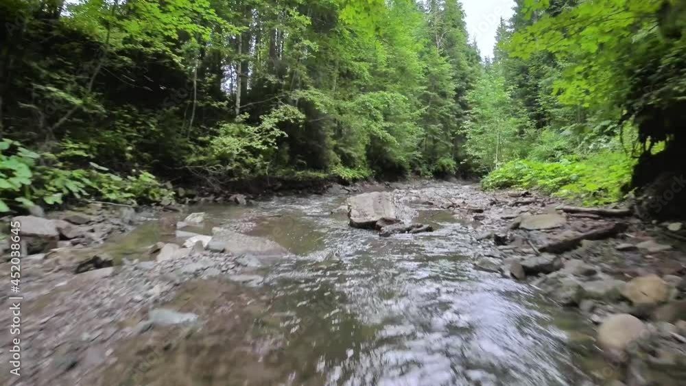 Smooth, rapid flight over a mountain river close to the water, among a dense forest. Mystical mountain landscape. Filmed on FPV drone. Smooth, rapid flight over a mountain river close to the water, among a dense forest. Mystical mountain landscape. Filmed on FPV drone.
