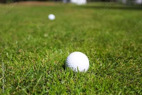 Golf ball on a green grass background