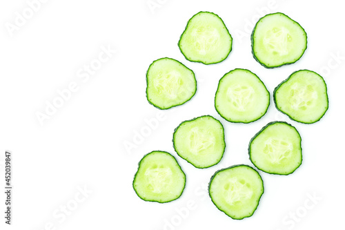 Fresh sliced cucumber cross-sections isolated on white background.