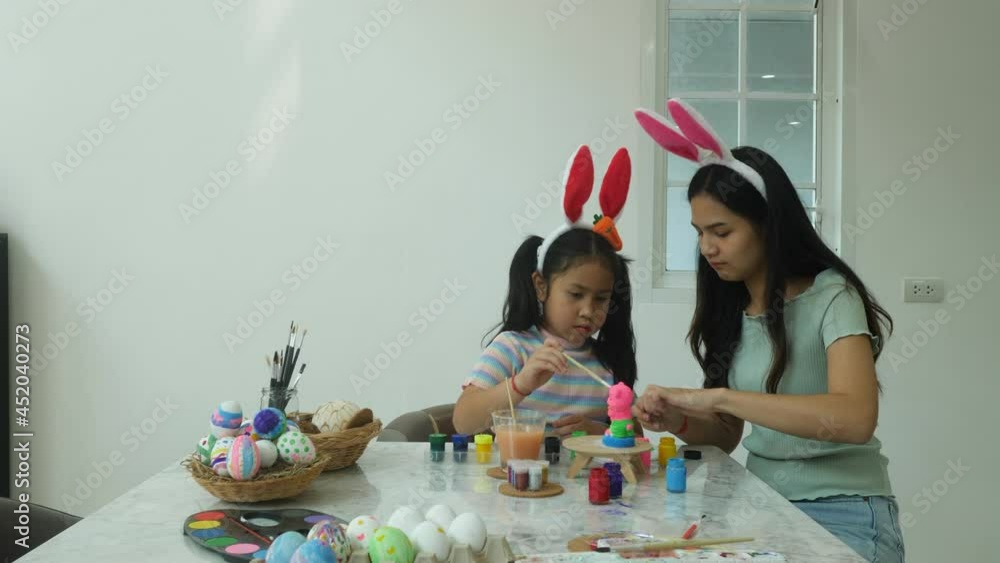 2 sisters children are happy fun and enjoy together to making Easter egg in holiday at home, wearing rabbit ear, family childhood concept 2 sisters children are happy fun and enjoy together to making Easter egg in holiday at home, wearing rabbit ear, family childhood concept
