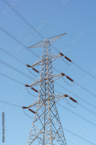 high power lines with blue sky background. high voltage tower