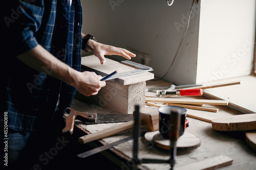 Man in the workshop with a wood