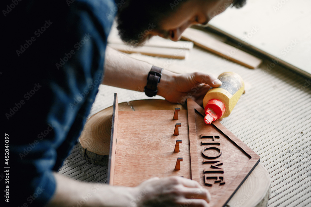 Woodworker applying glue to coards Woodworker applying glue to coards