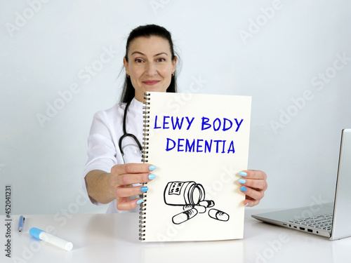  LEWY BODY DEMENTIA text in list. Doctor looking for something at laptop.