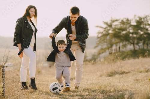 Stylish family walking on a spring field