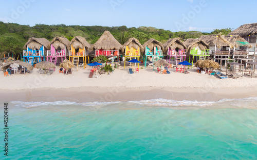 Colorful small houses in a caribbean beach with white sand and turquoise ocean © Diego Gomez