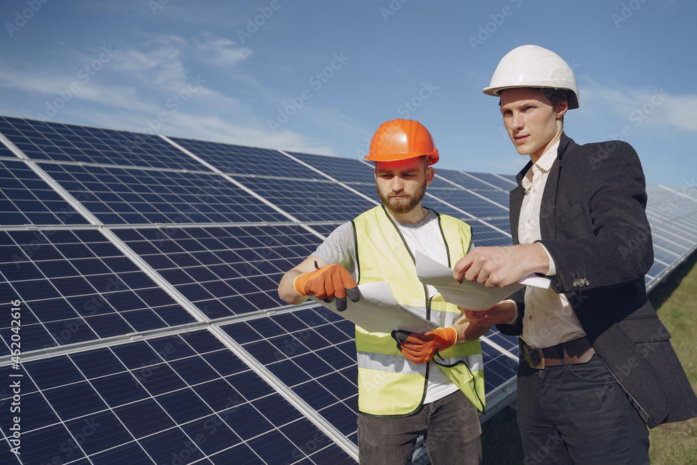 Foreman and businessman at solar energy station. Foreman and businessman at solar energy station.