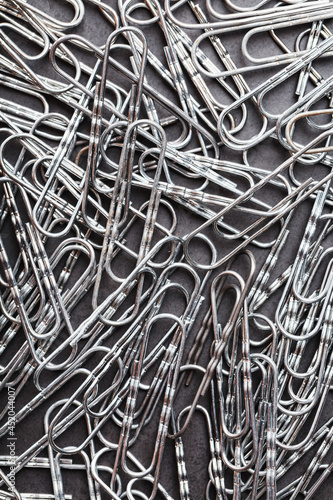 Silver paper clips textured background full screen