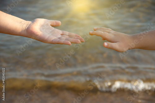 hand of mom and baby on the background of the sea  © tanya78