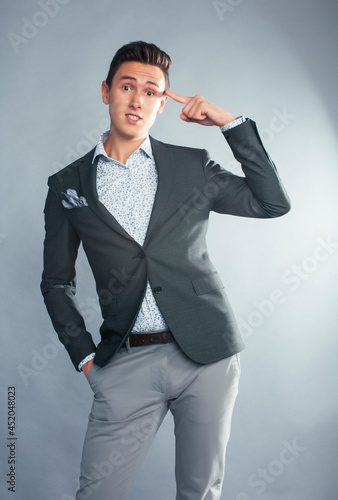 young pretty businessman posing emotional gesturing on white background, lifestyle people concept