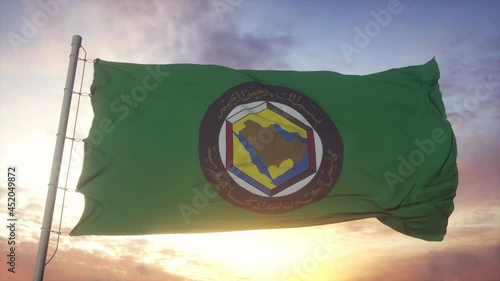 Flag of Gulf Cooperation Council waving in the wind, sky and sun background photo