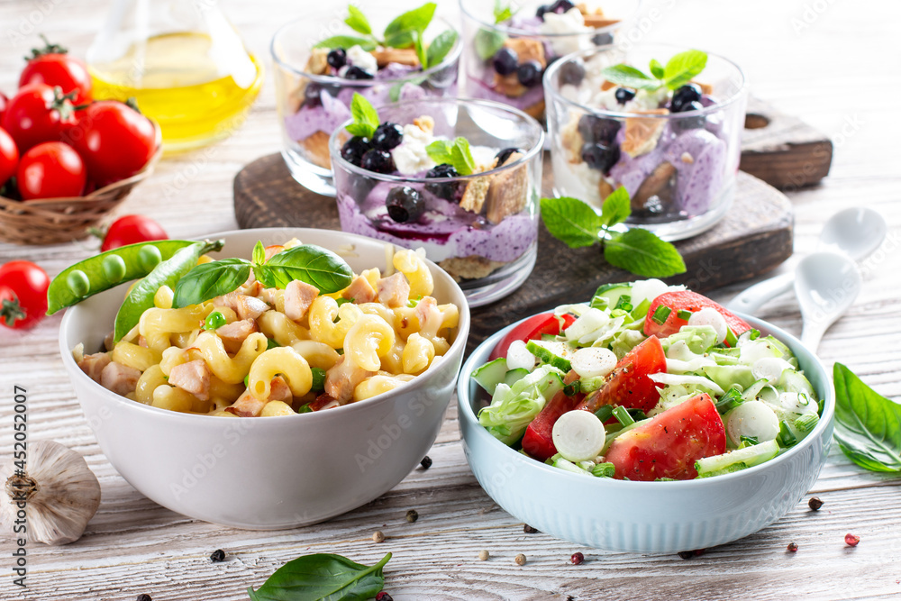 Three-course set menu for a nutritious healthy lunch. Three course set on a table in a business lunch, food set lunch. Full set of three dishes for lunch Three-course set menu for a nutritious healthy lunch. Three course set on a table in a business lunch, food set lunch. Full set of three dishes for lunch