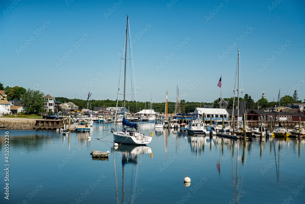 sailboats anchored in a bay of Maine coast fishing port