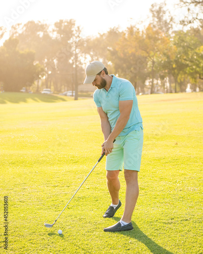 playing golfer in cap with golf club, recreation