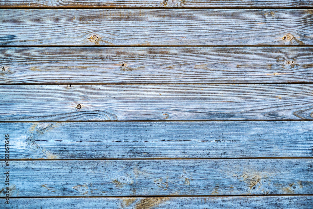 Old blue scratched wooden background with pieces of old paint and screws nails. Rustic obsolete boards of wall, door or floor. Selective focus Old blue scratched wooden background with pieces of old paint and screws nails. Rustic obsolete boards of wall, door or floor. Selective focus