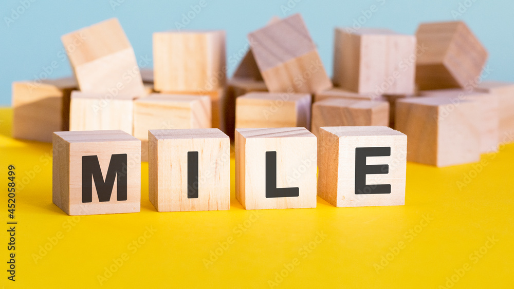 mile word construction with letter blocks and a shallow depth of field