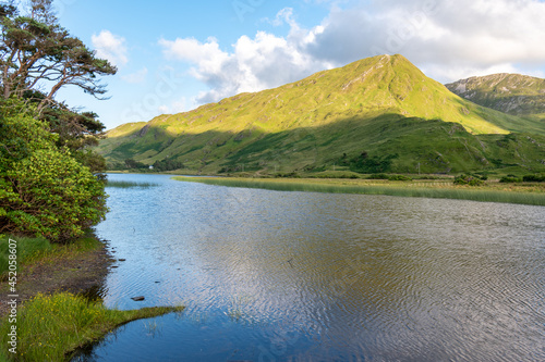 View over Pollacapall Lake to Green mountain, Connemara National Park, Ireland photo