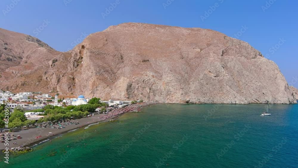 Santorini, Greece: Aerial view of Perissa, village with famous black sand beach Paralia Perissa on Santorini (Thira or Thera) island, Mediterranean Sea - landscape panorama of Europe from above Santorini, Greece: Aerial view of Perissa, village with famous black sand beach Paralia Perissa on Santorini (Thira or Thera) island, Mediterranean Sea - landscape panorama of Europe from above
