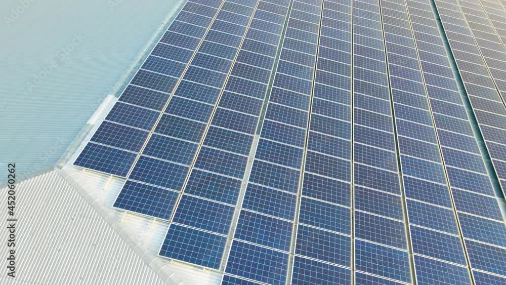 Aerial view of surface of blue photovoltaic solar panels mounted on building roof for producing clean ecological electricity. Production of renewable energy concept. Aerial view of surface of blue photovoltaic solar panels mounted on building roof for producing clean ecological electricity. Production of renewable energy concept.