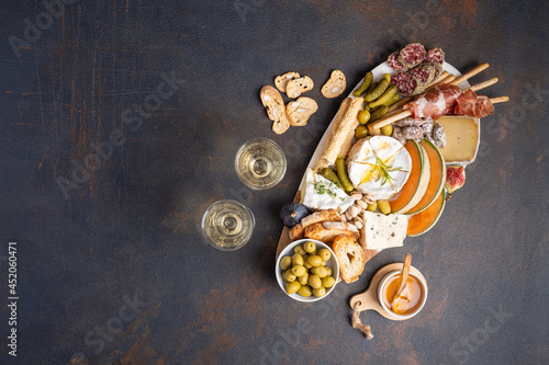 Fotótapéta Snacks table with Italian snacks and wine in glasses