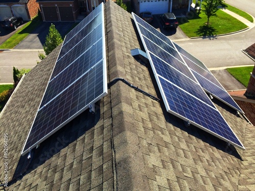 Side view at solar panels on residential roof in Ontario, Canada.Production of solar panels. Green energy concept.
