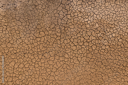 Tablou pe pânză Brown clay texture, cracked mud background