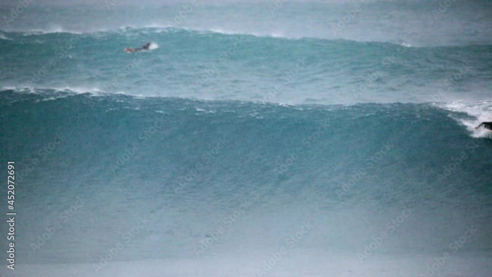 Slow Motion Lockdown Of Large Crashing Waves In A Rain Storm With A Single Surfer Paddling At Sea - Oahu, Hawaii Slow Motion Lockdown Of Large Crashing Waves In A Rain Storm With A Single Surfer Paddling At Sea - Oahu, Hawaii
