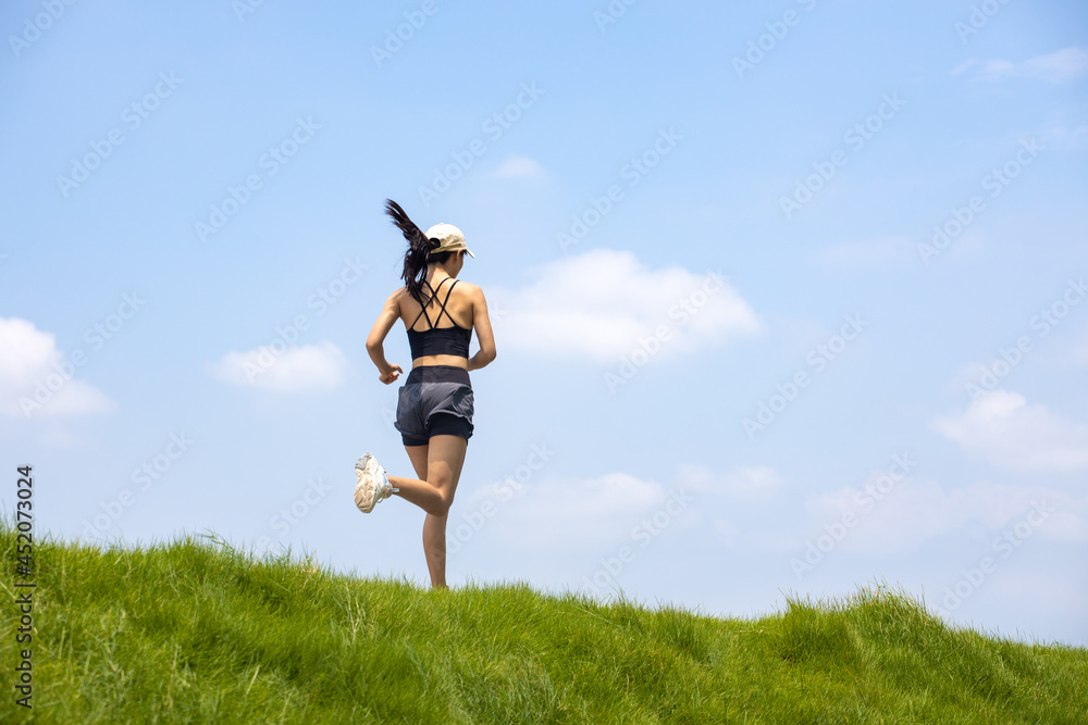 Young Asian girls running in the morning for fitness Young Asian girls running in the morning for fitness