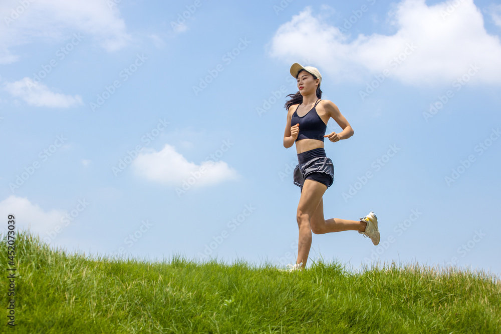 Young Asian girls running in the morning for fitness Young Asian girls running in the morning for fitness