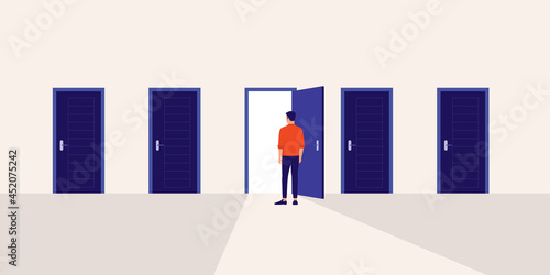 Young Man Standing In Front Of A Door With Light Shines Through The Doorway. Choices Make In Life Is Like A Door Opening Concept.