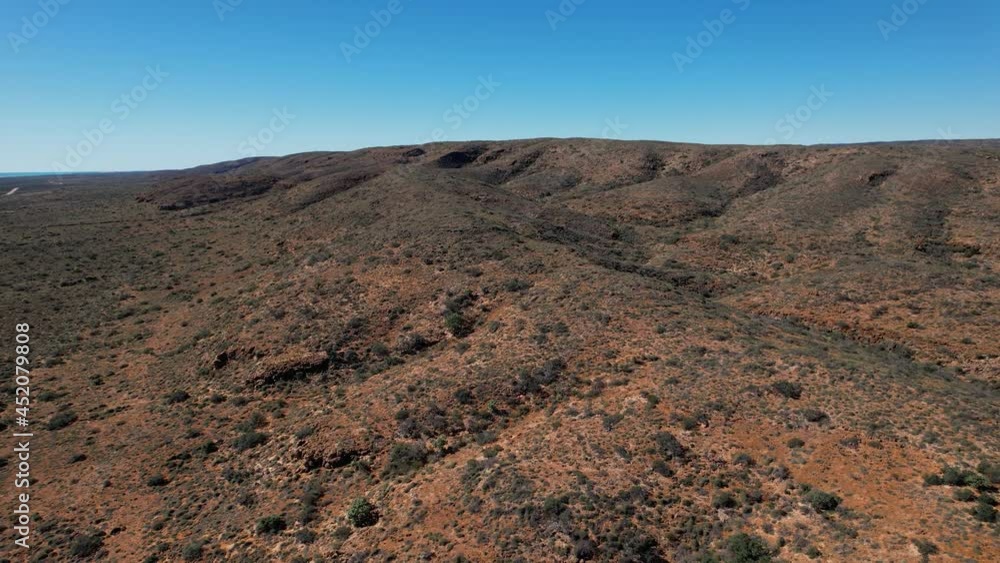 Cinematic aerial view of a wild australian desert landscape mountain ranges Cinematic aerial view of a wild australian desert landscape mountain ranges