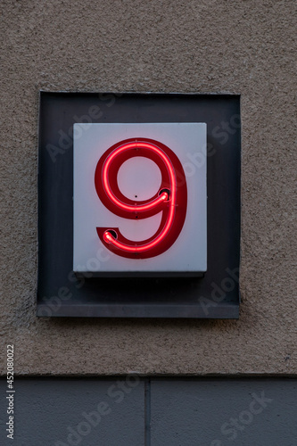 Stockholm, Sweden Aug 20, 2021 A neon number 9 on the facade of a house. photo