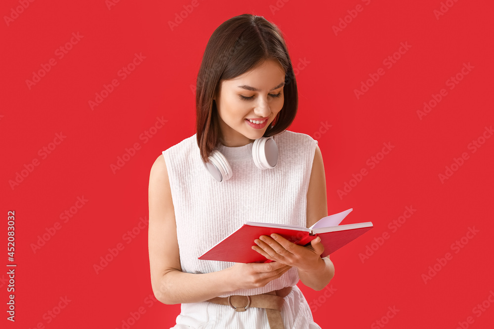 Young woman reading book on color background Young woman reading book on color background