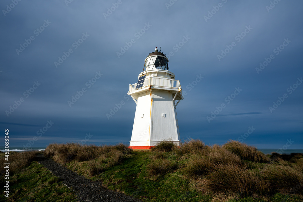 Waipapa lighthouse in the Catlins New Zealand with stormy clouds