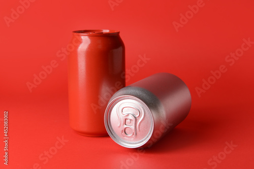 Cans of soda on color background