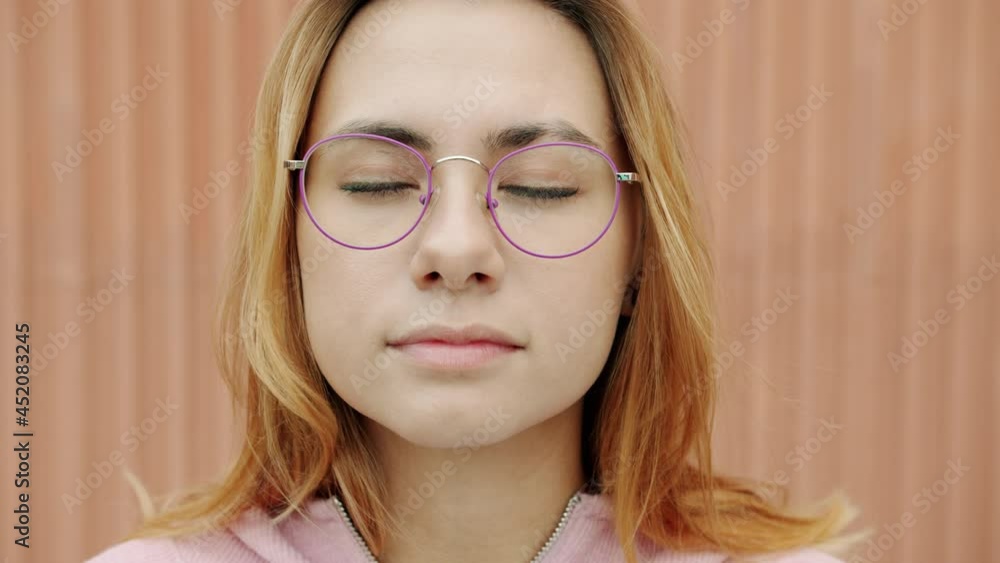 Close-up portrait of beautiful young blonde standing outdoors with closed eyes enjoying peace and relaxation. People and carefree youth concept. Close-up portrait of beautiful young blonde standing outdoors with closed eyes enjoying peace and relaxation. People and carefree youth concept.