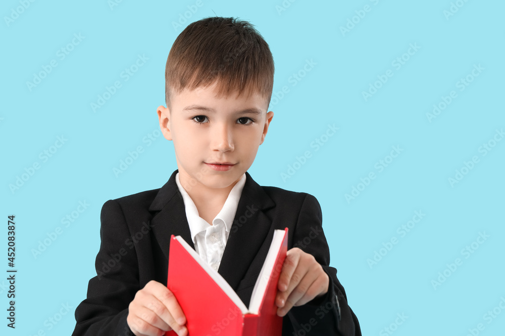 Little schoolboy reading book on color background Little schoolboy reading book on color background