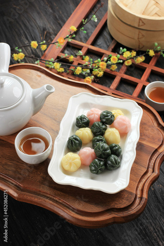 Three Color Kkultteok is Ball Shaped Rice Cake Filled with Honey and Sesame Syrup, Korean Traditional Cake for Chuseok Day. Concept Korean Culture photo