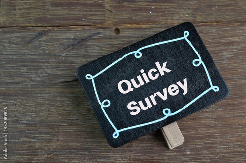 Wooden tag written with text QUICK SURVEY