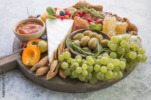 Charcuterie board. Cheese platter. Assortment of tasty appetizers or antipasti. Top view. Copy space.