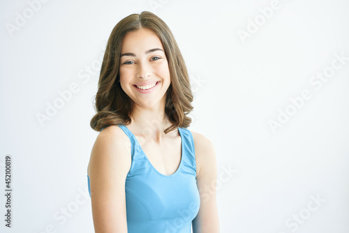 cheerful brunette fashion hairstyle blue tank top posing lifestyle fashion yes © SHOTPRIME STUDIO
