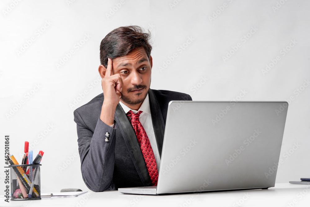 Young indian man in suit and working on laptop at office Young indian man in suit and working on laptop at office
