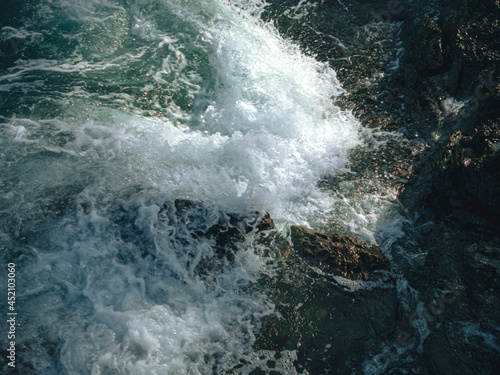 Tide wave on the rocky beach.