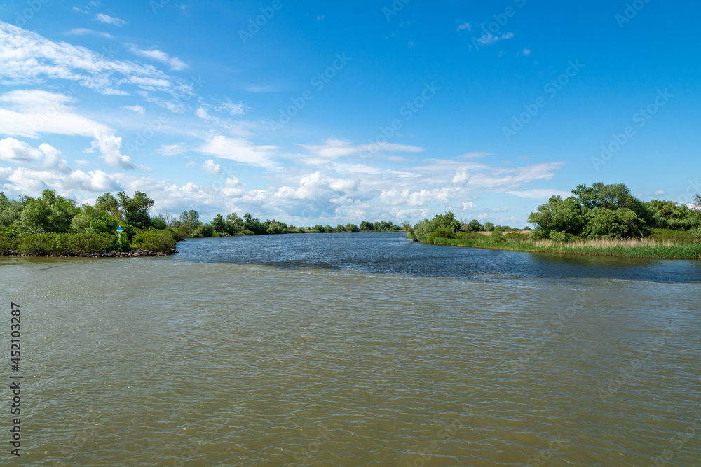 two streams of water mixing, danube delta