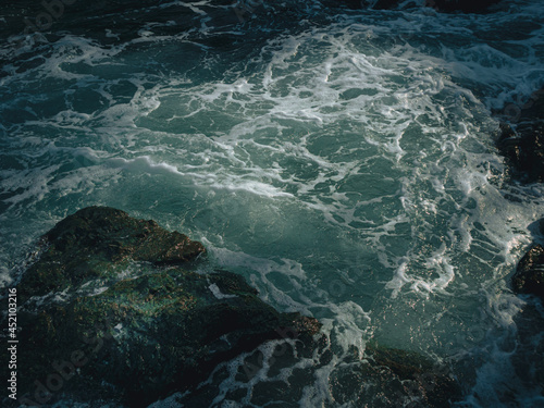 Tide wave on the rocky beach.