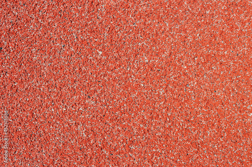 Texture of a rubber crumb (rubber asphalt) is used in stadium. Resilient coating for sports and athletics fields, jogging, running track and cycling paths.