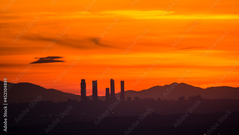 Panoramic of the business area of the four towers of Madrid with the sun setting behind