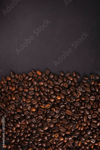 coffee beans close up. Top view. Texture of roasted brown coffee beans.Top view with copy space.