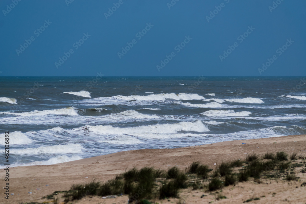 Arabian Ocean waves with foam of blue and turquoise color. Sea foam creating amazing shapes and patterns like glacier. Abstract Arabian Ocean blue water with white wave for background. Arabian Ocean waves with foam of blue and turquoise color. Sea foam creating amazing shapes and patterns like glacier. Abstract Arabian Ocean blue water with white wave for background.