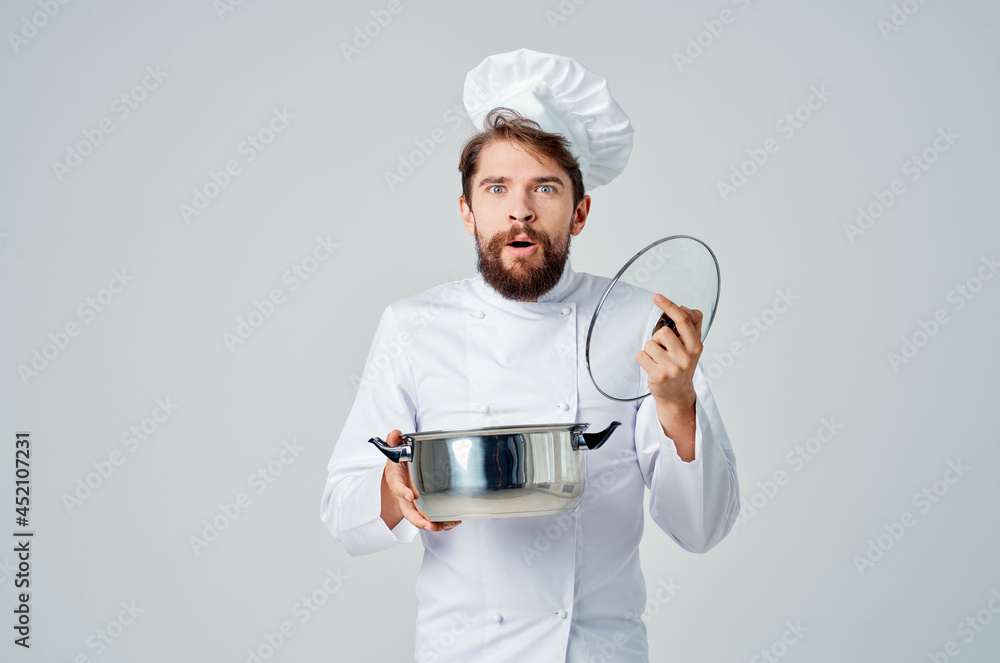male professional chef with a saucepan in his hands preparing food restaurant male professional chef with a saucepan in his hands preparing food restaurant